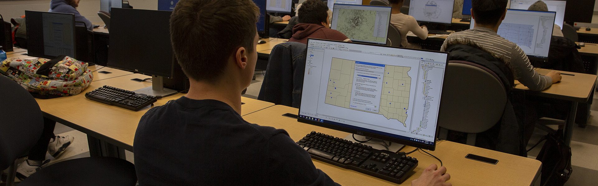 A student looks at a map on a computer.