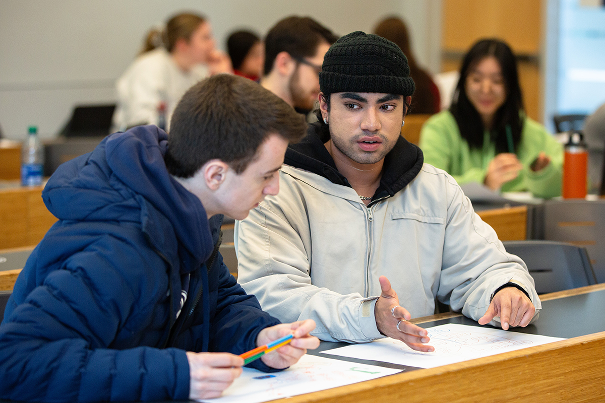 Students talking during a class project.
